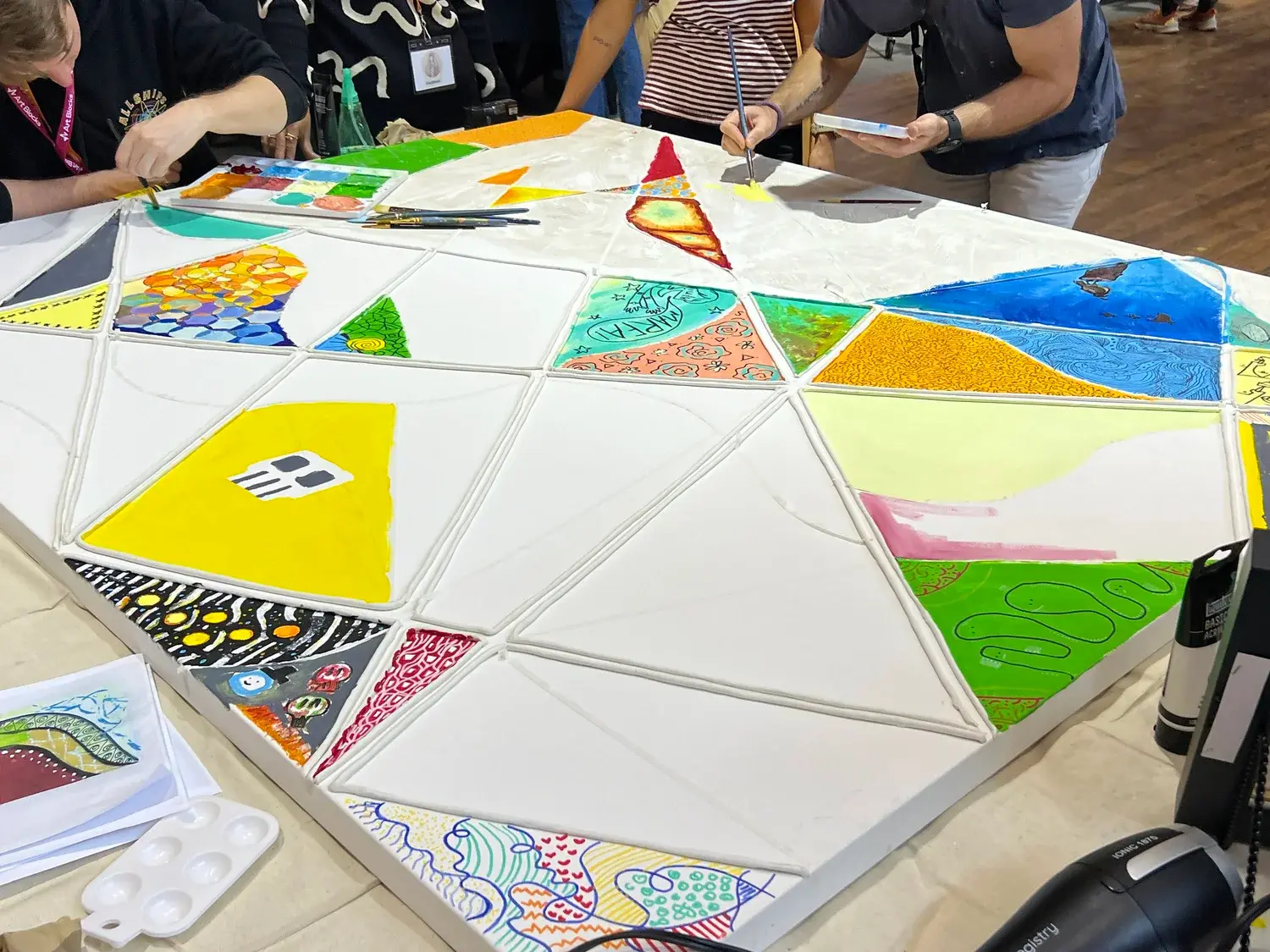 Participants painting a shared canvas at Art Blocks Marfa Weekend